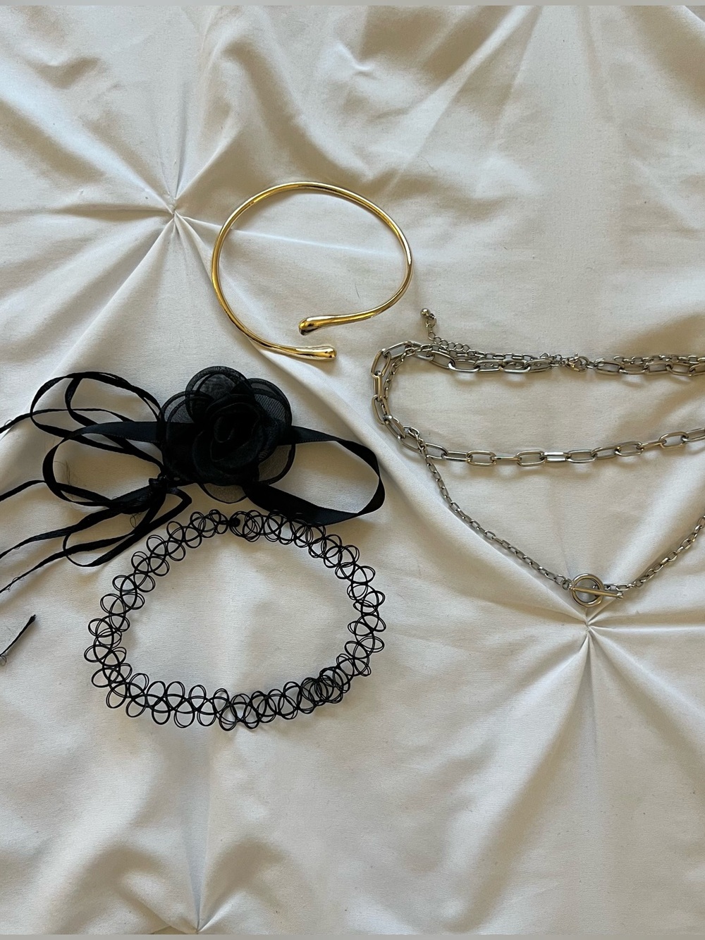 Bundle of choker necklaces and arm bangle